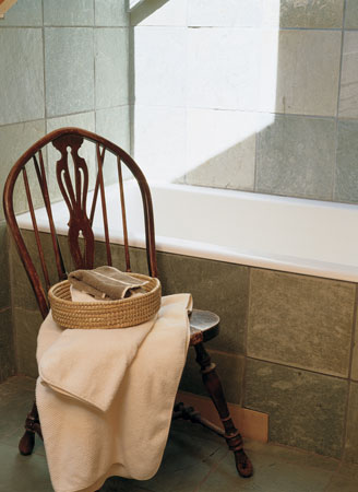 
The slate shower-surround and backsplash in the master bathroom are embedded with fossils. A skylight offers a view of the heavens. Fluffy organic cotton towels stand ready.
